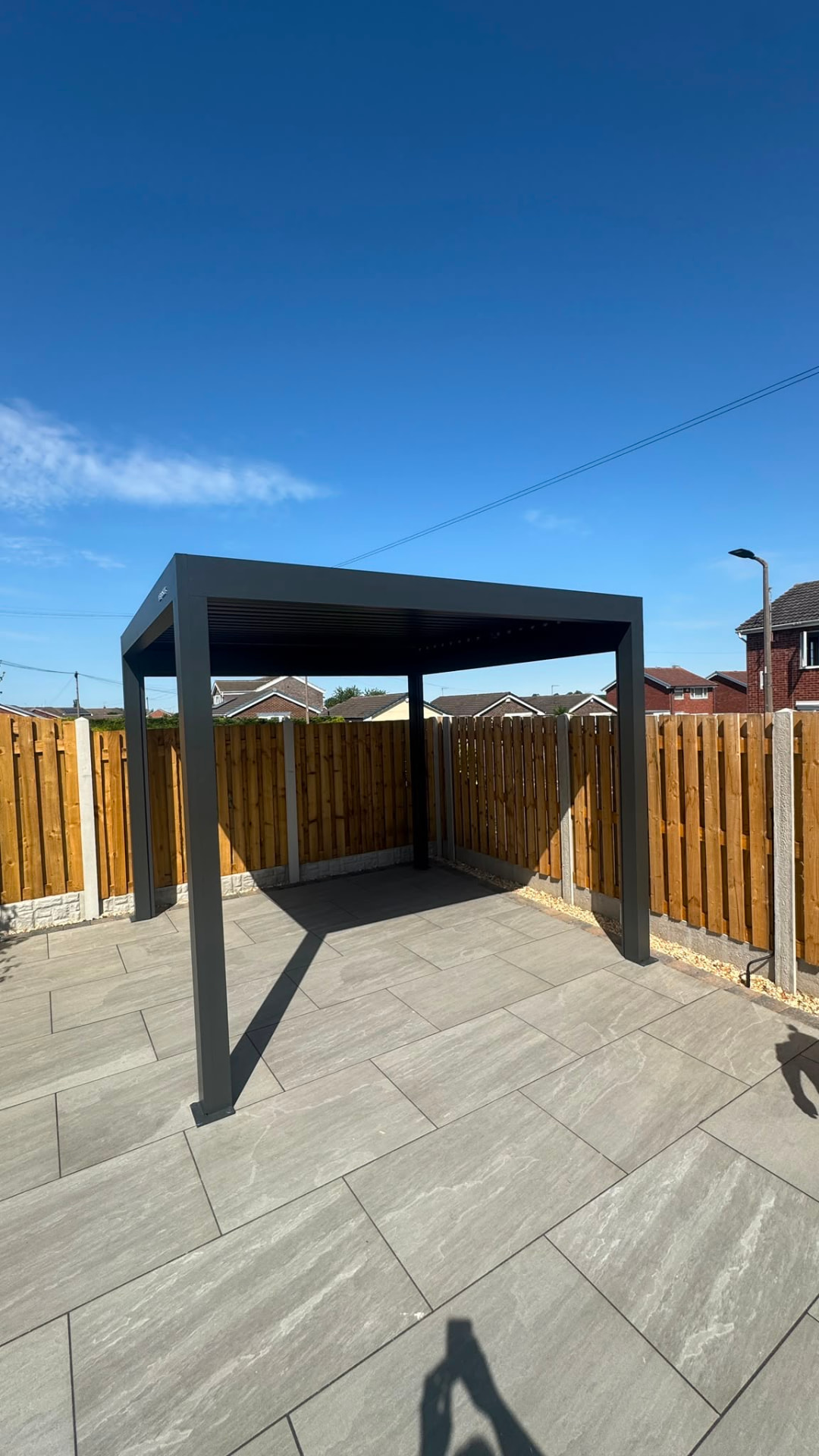 Motorised louvered pergola on a porcelain paved patio