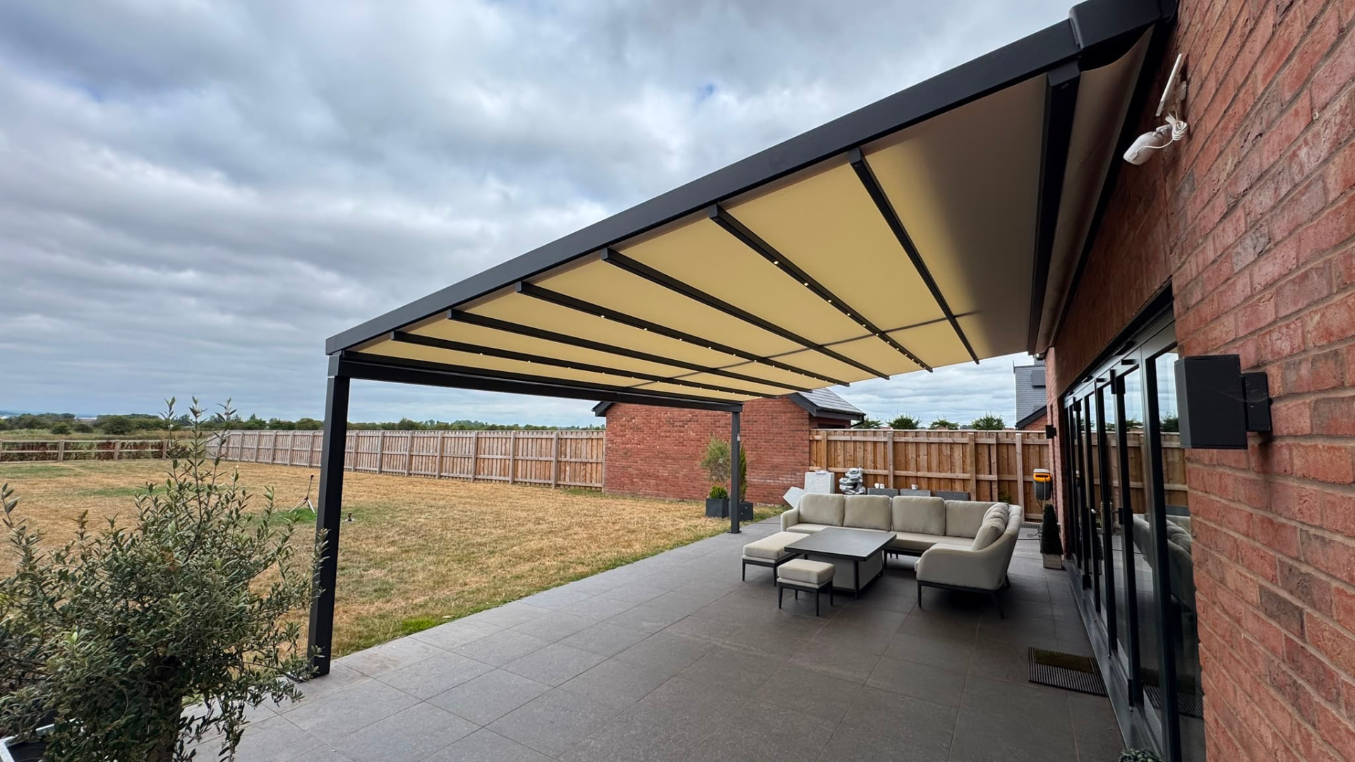 Large retractable awning shading a patio lounge area
