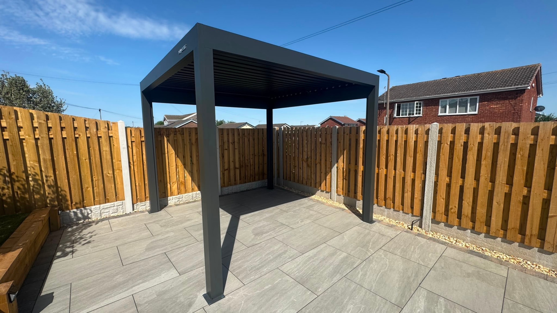 Louvered pergola with integrated LED lighting in a rear garden