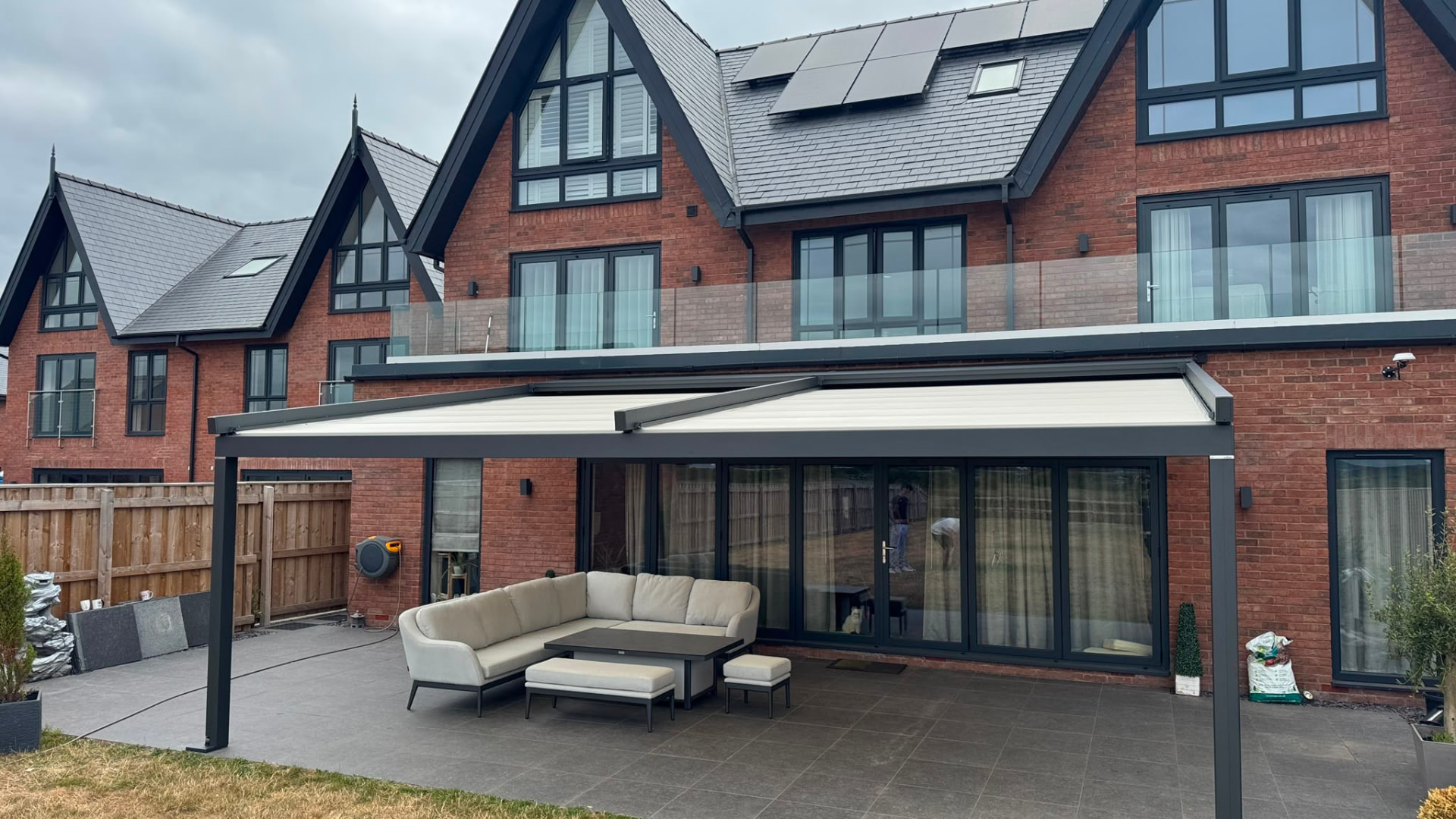 Twin retractable awnings fitted under an aluminium veranda frame