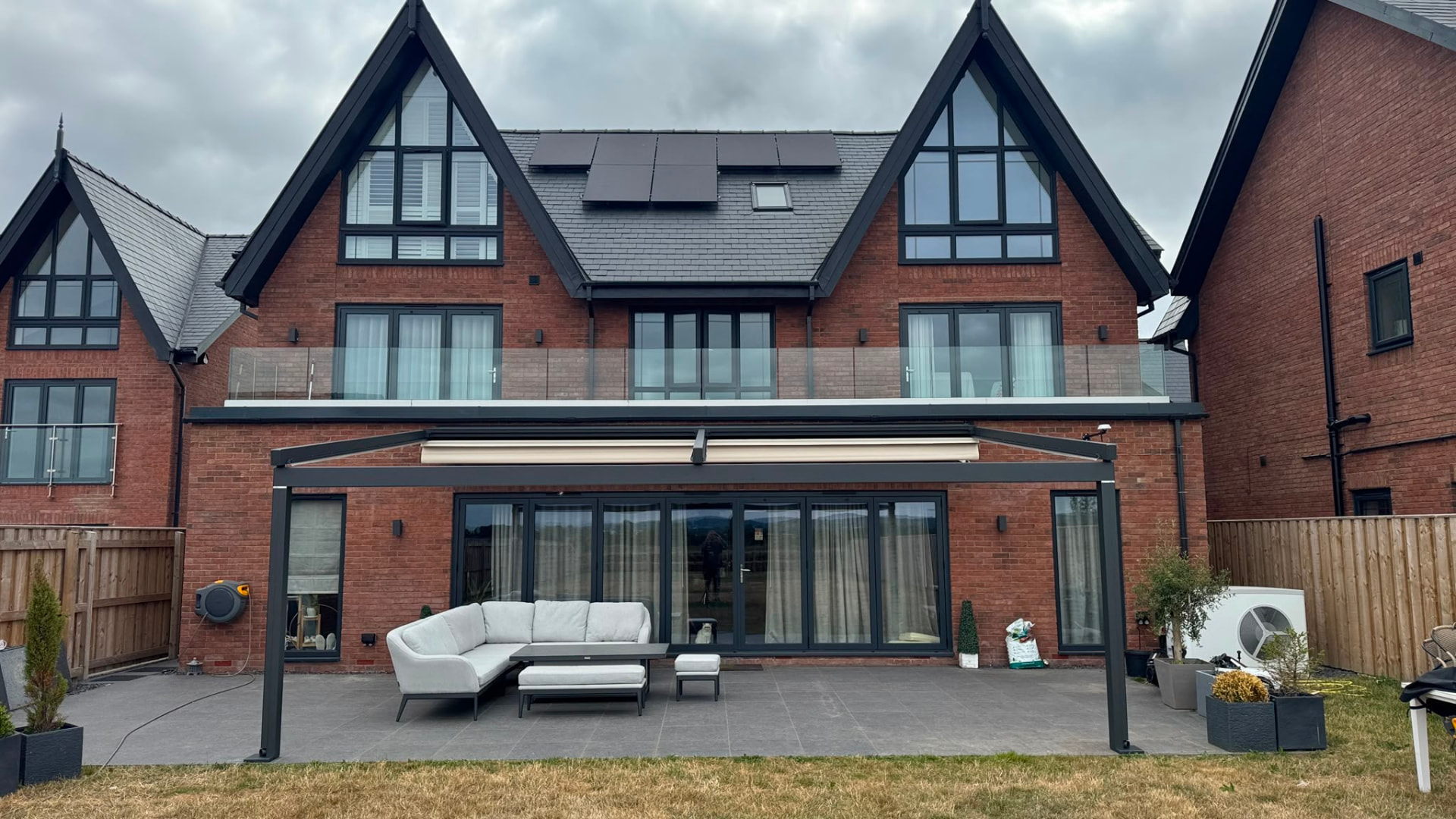 Retractable awning fitted to a veranda at the rear of a family home