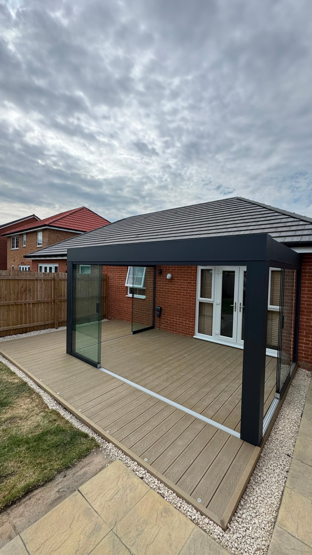Glass room built on composite decking at the rear of a bungalow