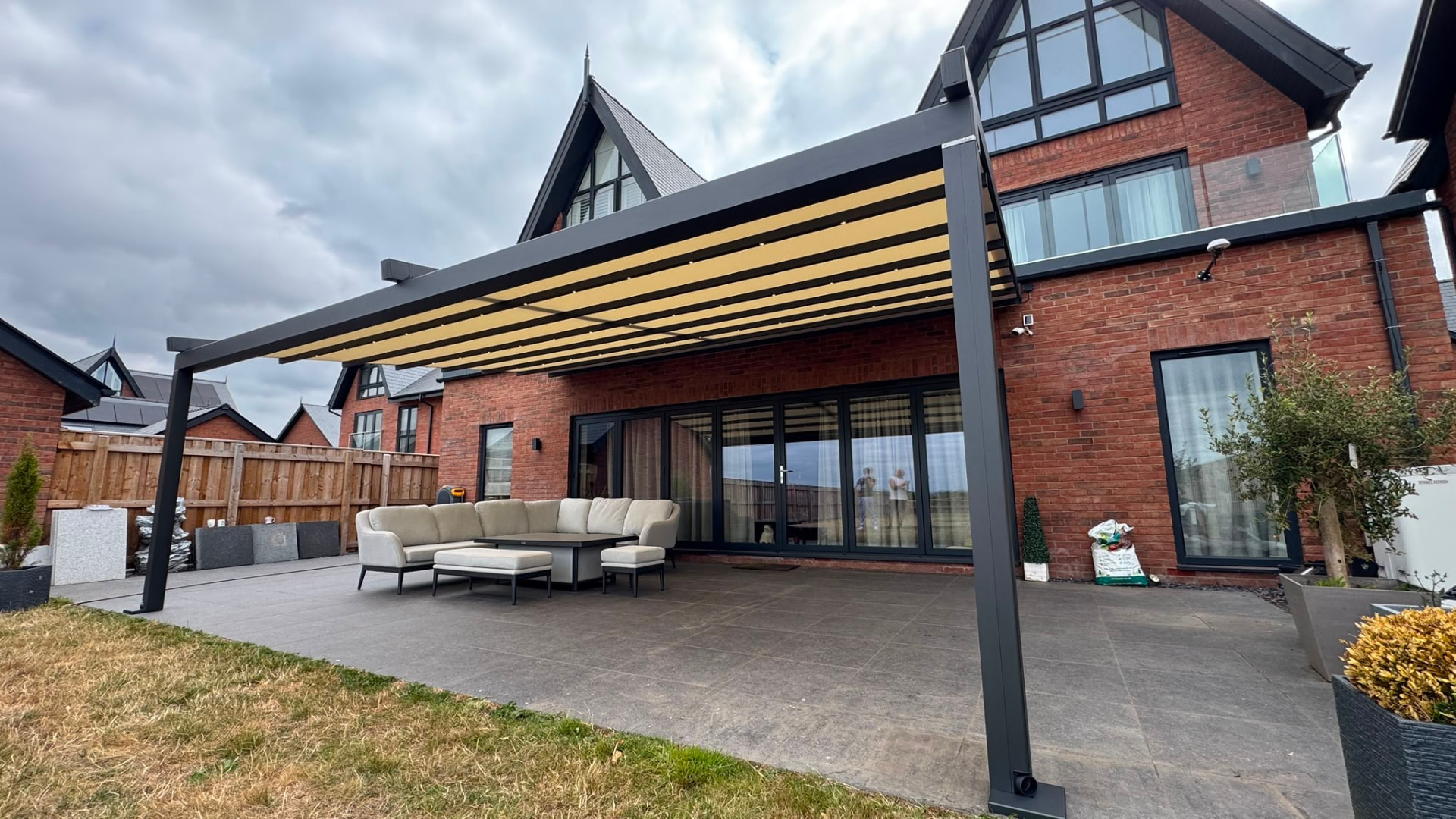 Retractable awning extended from an aluminium veranda over a large patio