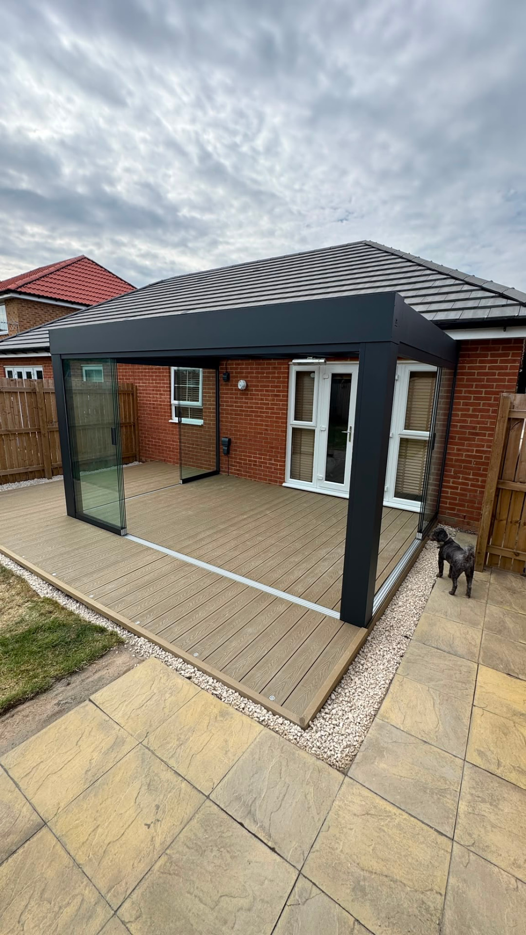 Glass room with sliding glass sides over composite decking