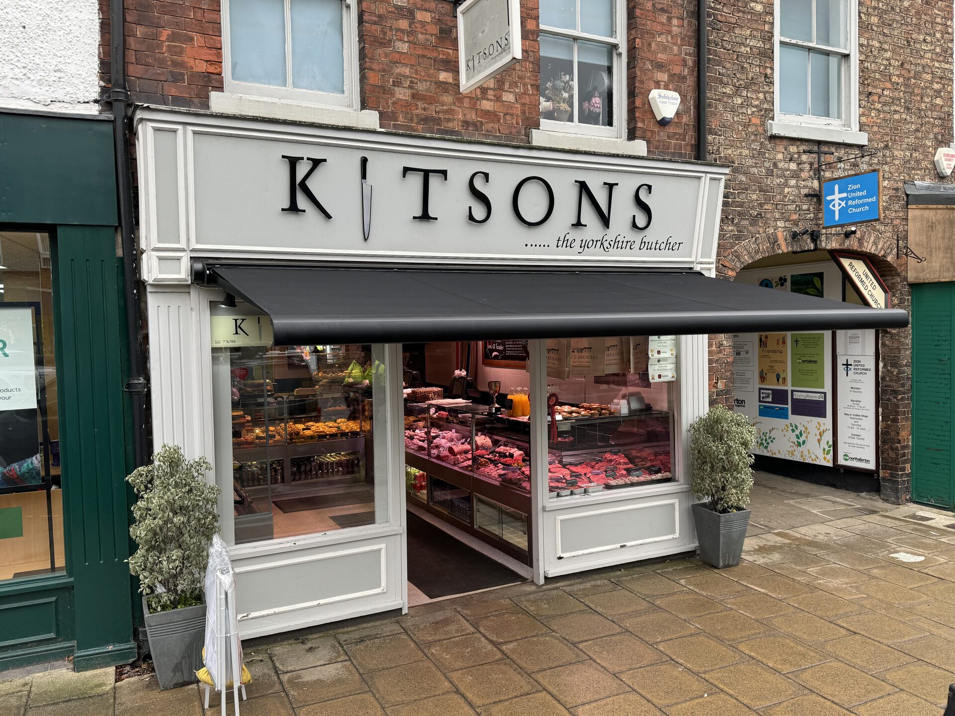 Branded commercial awning over a restaurant terrace